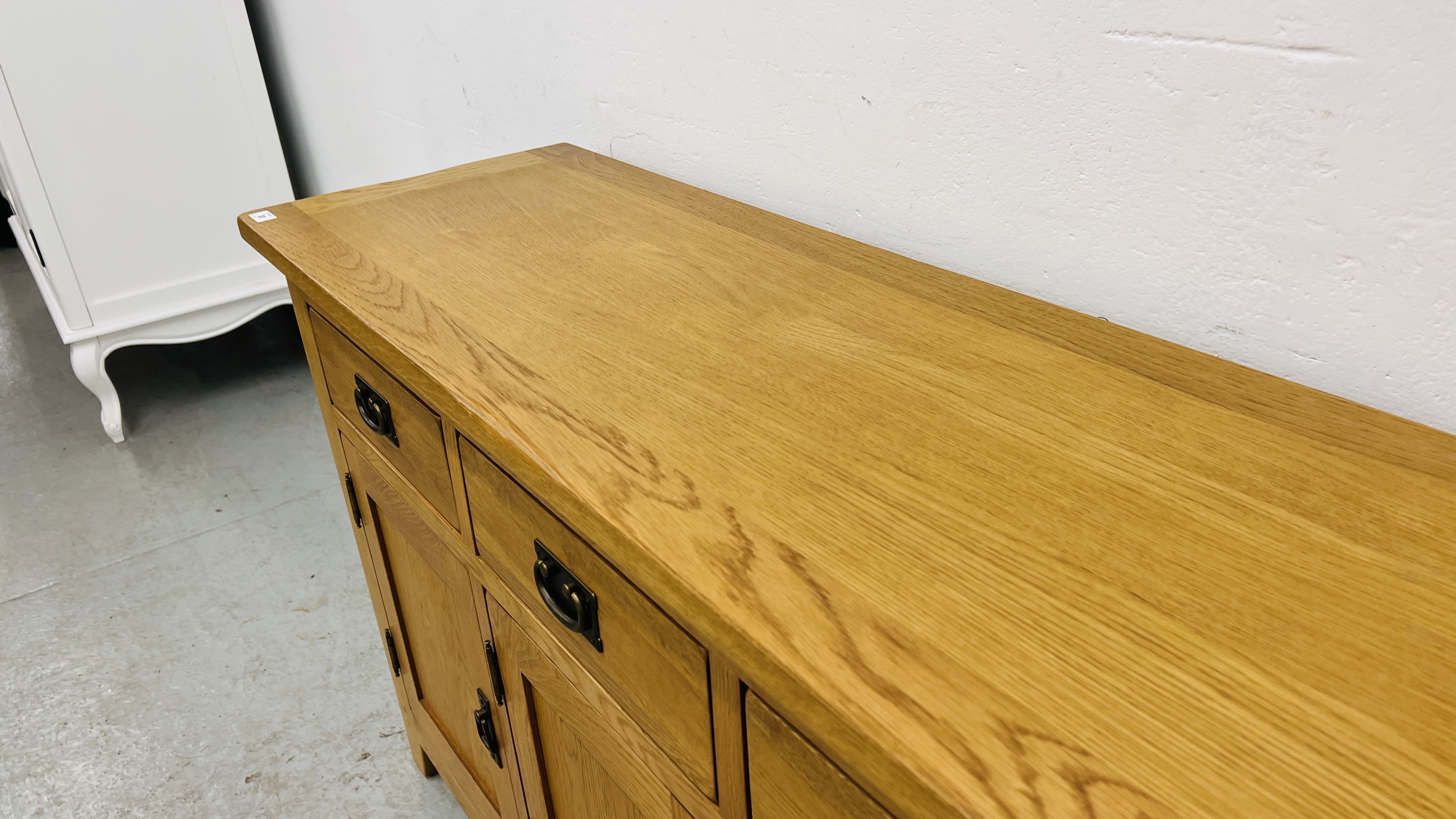 MODERN OAK THREE DRAWER THREE DOOR SIDEBOARD WITH BRASS EFFECT HANDLES WIDTH 139CM. DEPTH 42CM. - Image 7 of 13