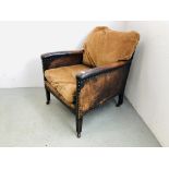 AN ANTIQUE LEATHER ARMCHAIR WITH STUD DETAIL