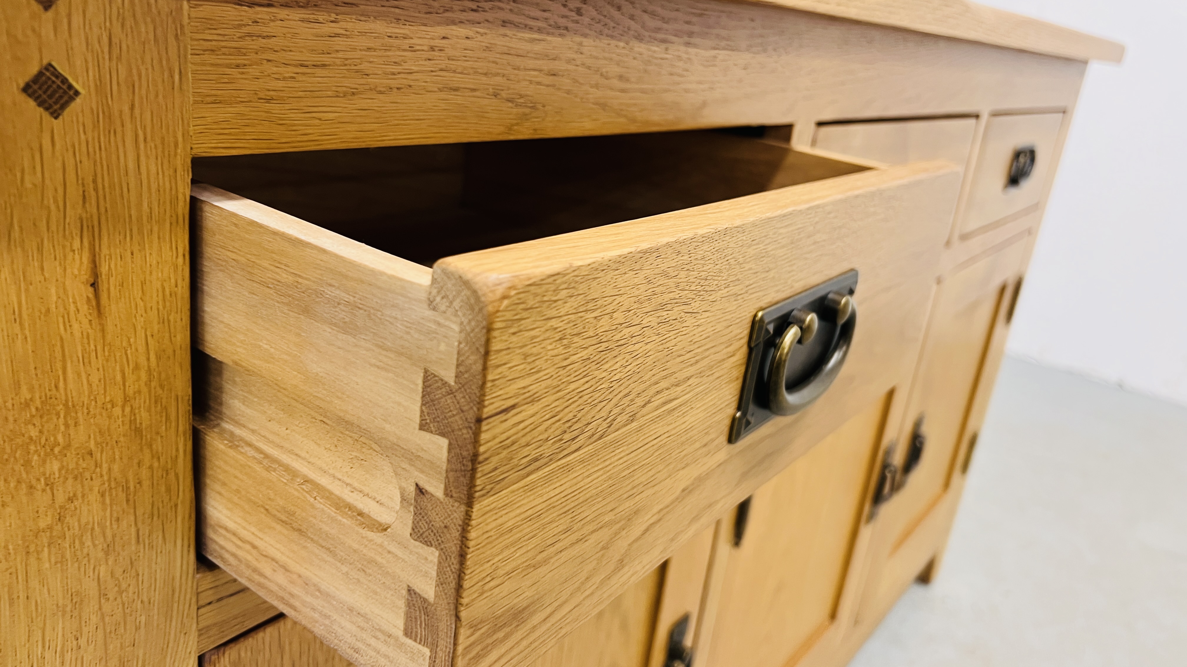 MODERN OAK THREE DRAWER THREE DOOR SIDEBOARD WITH BRASS EFFECT HANDLES WIDTH 139CM. DEPTH 42CM. - Image 12 of 13