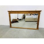 A LARGE PINE FRAMED OVER MANTEL MIRROR 127 X 73CM.