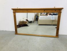 A LARGE PINE FRAMED OVER MANTEL MIRROR 127 X 73CM.