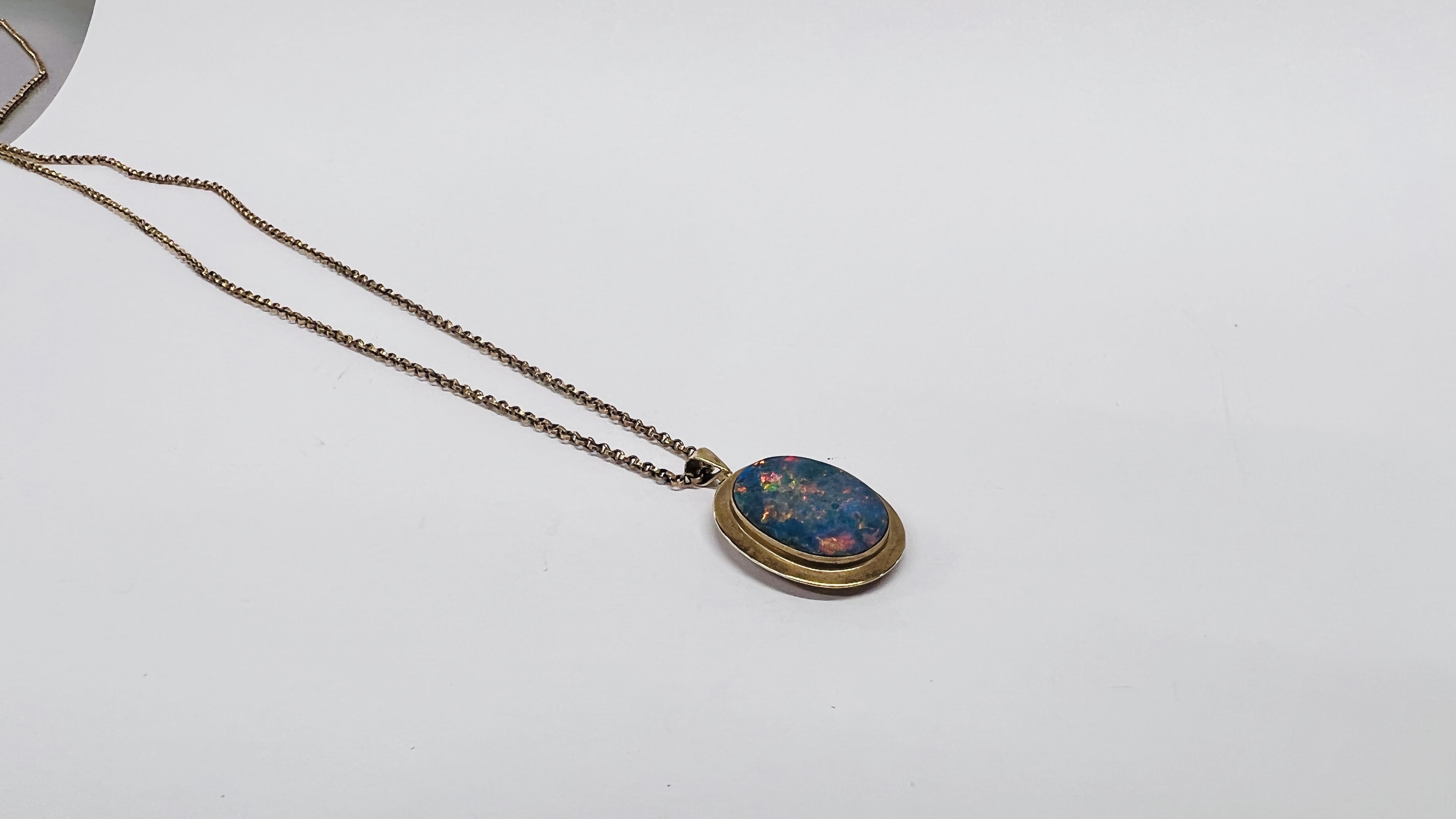 A 10CT PENDANT FRAMING AN OVAL OPAL ON A 9CT GOLD CHAIN. - Image 2 of 9