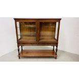 AN EDWARDIAN OAK GLAZED DISPLAY CABINET ABOVE A TWO DRAWER AND OPEN SHELF BASE WIDTH 122CM.