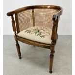 AN ANTIQUE TUB CHAIR WITH RATTAN CANEWORK AND TAPESTRY SEAT CUSHION