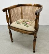 AN ANTIQUE TUB CHAIR WITH RATTAN CANEWORK AND TAPESTRY SEAT CUSHION