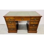 AN EDWARDIAN MAHOGANY NINE DRAWER KNEEHOLE DESK THE TOP WITH GREEN LEATHER WRITING SURFACE WIDTH