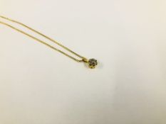 AN 18K GOLD DIAMOND SOLITAIRE PENDANT ON A FINE 18K GOLD CHAIN.