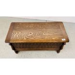 A SMALL REPRODUCTION BLANKET BOX WITH CARVED DETAIL, WIDTH 76.5CM. DEPTH 36CM. HEIGHT 40CM.