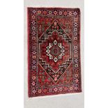 A SMALL MODERN PERSIAN RUG 122CM. X 75CM.