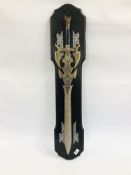A REPRODUCTION BARBERIAN SWORD ON WALL PLAQUE