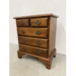 A REPRODUCTION MINIATURE OAK TWO OVER THREE CHEST OD DRAWERS WIDTH 50CM. DEPTH 32CM. HEIGHT 59CM.