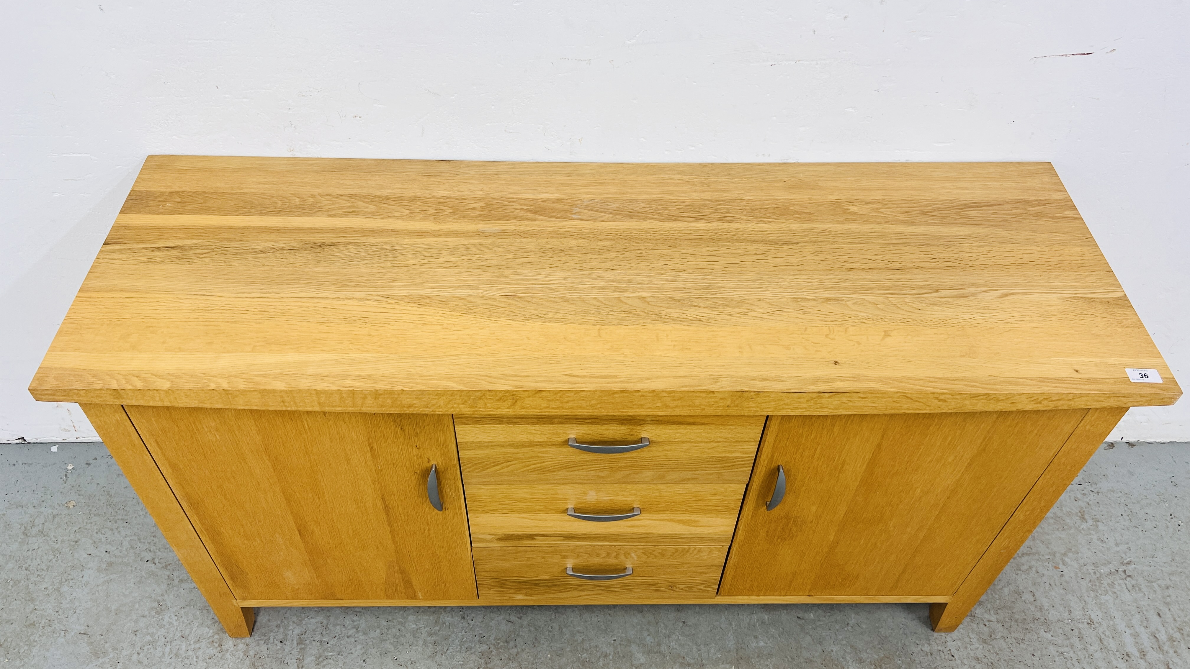 A SOLID OAK THREE DRAWER TWO DOOR SIDEBOARD WIDTH 137CM. DEPTH 45CM. HEIGHT 75CM. - Image 9 of 10