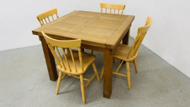 A SOLID OAK EXTENDING DINING TABLE ALONG WITH A SET OF FOUR BEECH WOOD DINING CHAIRS
