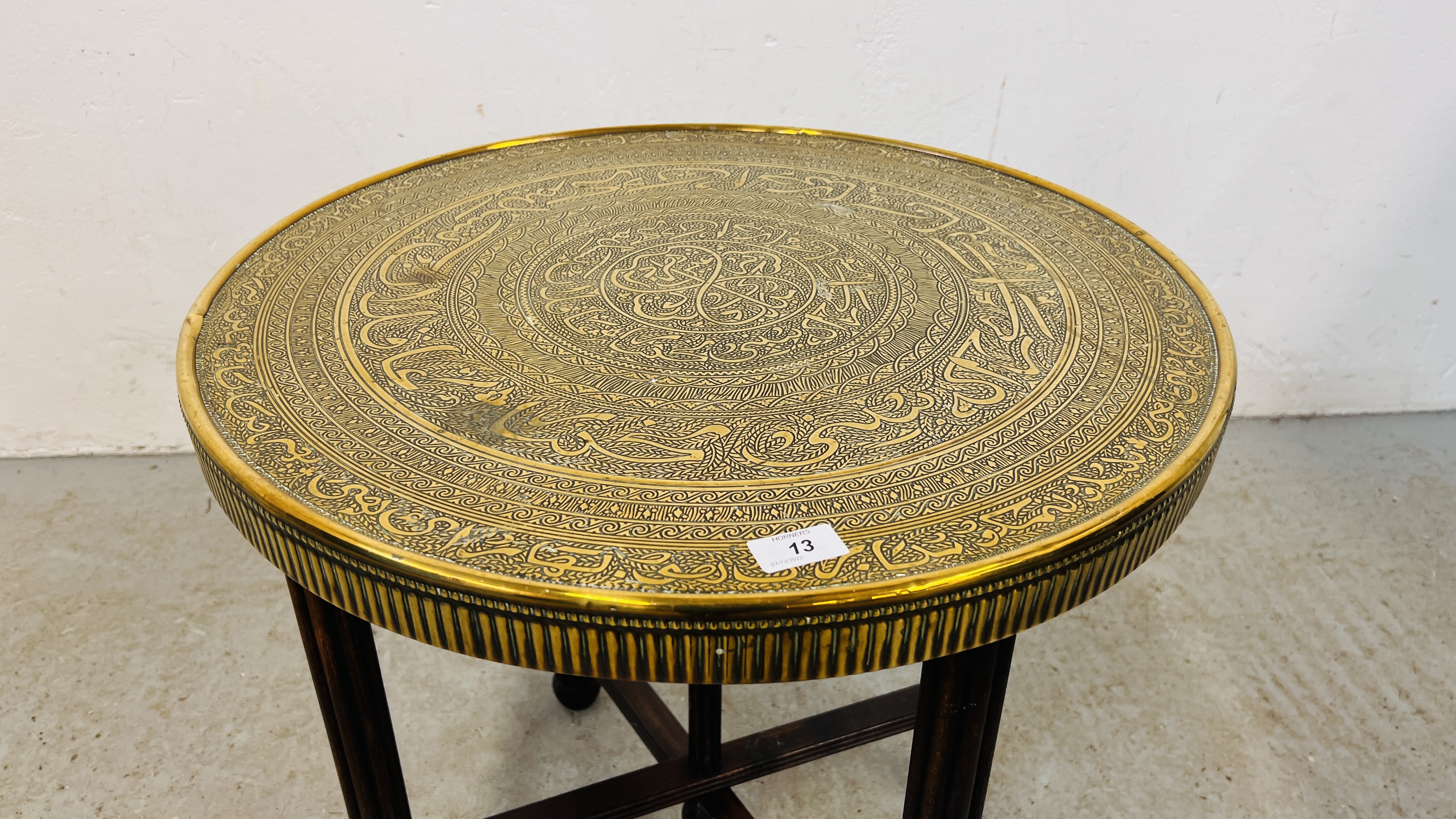 A CIRCULAR BRASS TOP OCCASIONAL TABLE WITH IRANIAN DESIGN ON FOLDING OAK BASE DIA. 59CM. - Image 2 of 5