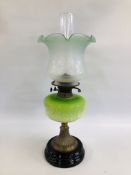 AN ANTIQUE OIL LAMP ON CIRCULAR BASE WITH BRASS DETAIL,