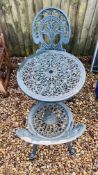 A DECORATIVE CAST METAL GARDEN PATIO BISTRO SET (TABLE AND 2 CHAIRS)
