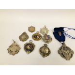 A COLLECTION OF NINE SILVER METALS ONE ENAMELLED EXAMPLE.