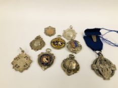 A COLLECTION OF NINE SILVER METALS ONE ENAMELLED EXAMPLE.