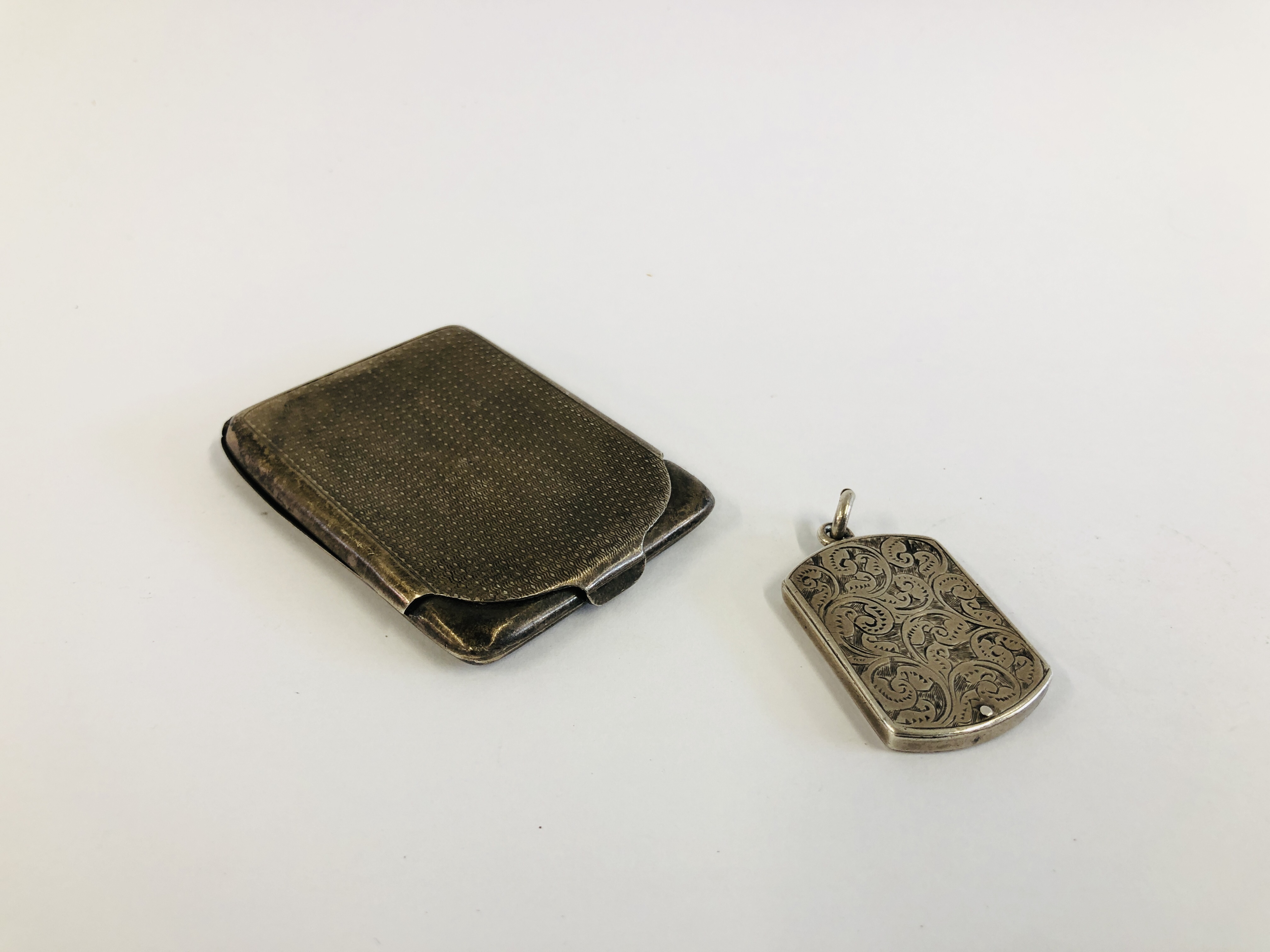 A SILVER STAMP HOLDER, CHESTER 1900 ALONG WITH A SILVER STAMP CASE, BIRMINGHAM 1924.