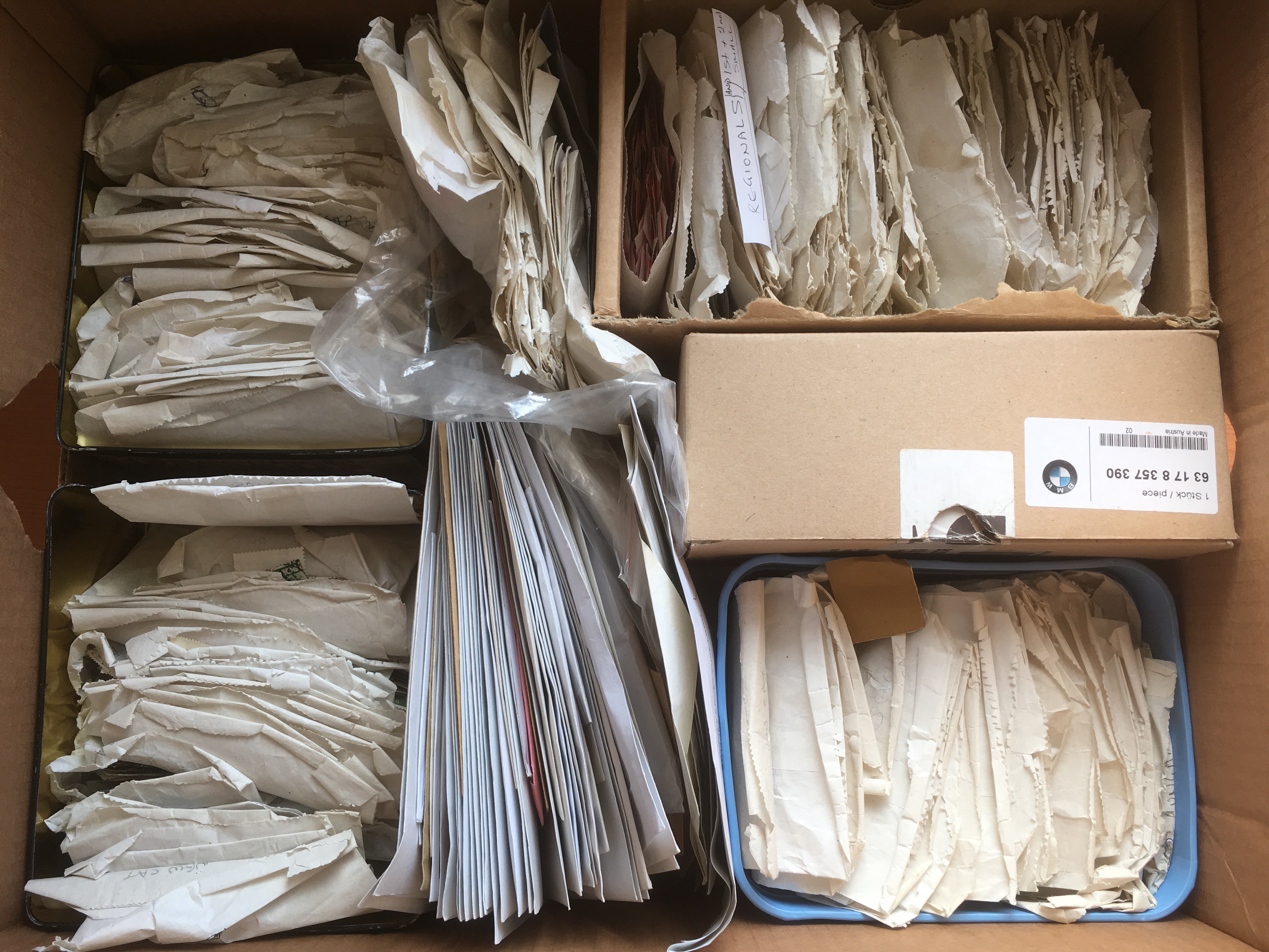 BOX WITH A VAST ALL WORLD STAMP ACCUMULATION SORTED INTO ENVELOPES BY COUNTRY OR ISSUE.