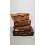 A GROUP OF THREE VINTAGE SUITCASES ALONG WITH A WICKER PICNIC BASKET