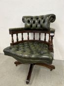 BOTTLE GREEN LEATHER BUTTON BACK REVOLVING OFFICE CHAIR.