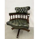 BOTTLE GREEN LEATHER BUTTON BACK REVOLVING OFFICE CHAIR.