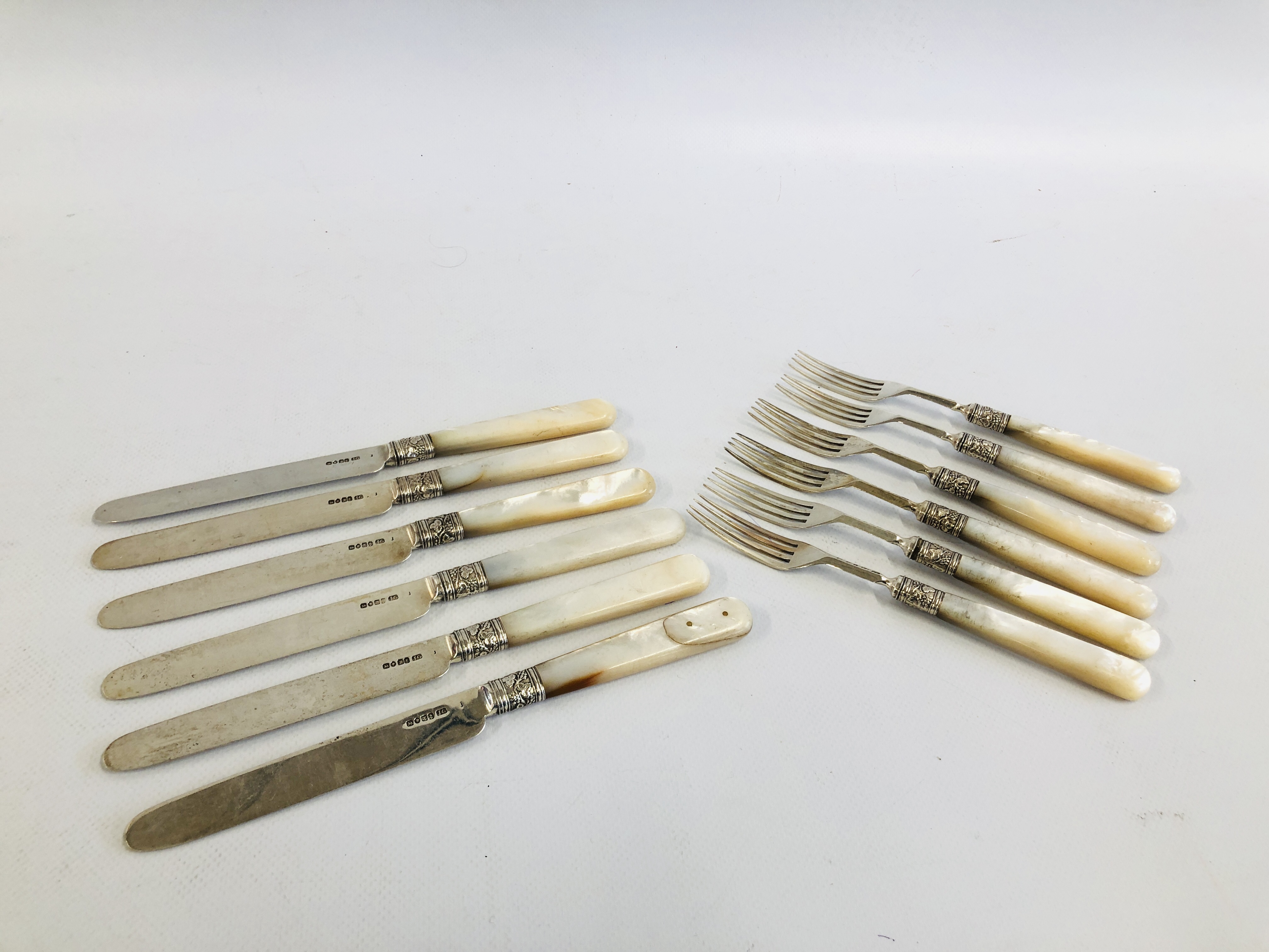 A SET OF SIX SILVER TEA KNIVES AND SIX SILVER FORKS, MOTHER OF PEARL HANDLES,