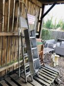 AN ALUMINIUM THREE SECTION LOFT LADDER WITH HAND RAIL AND A FIVE TREAD ALUMINIUM FOLDING STEP