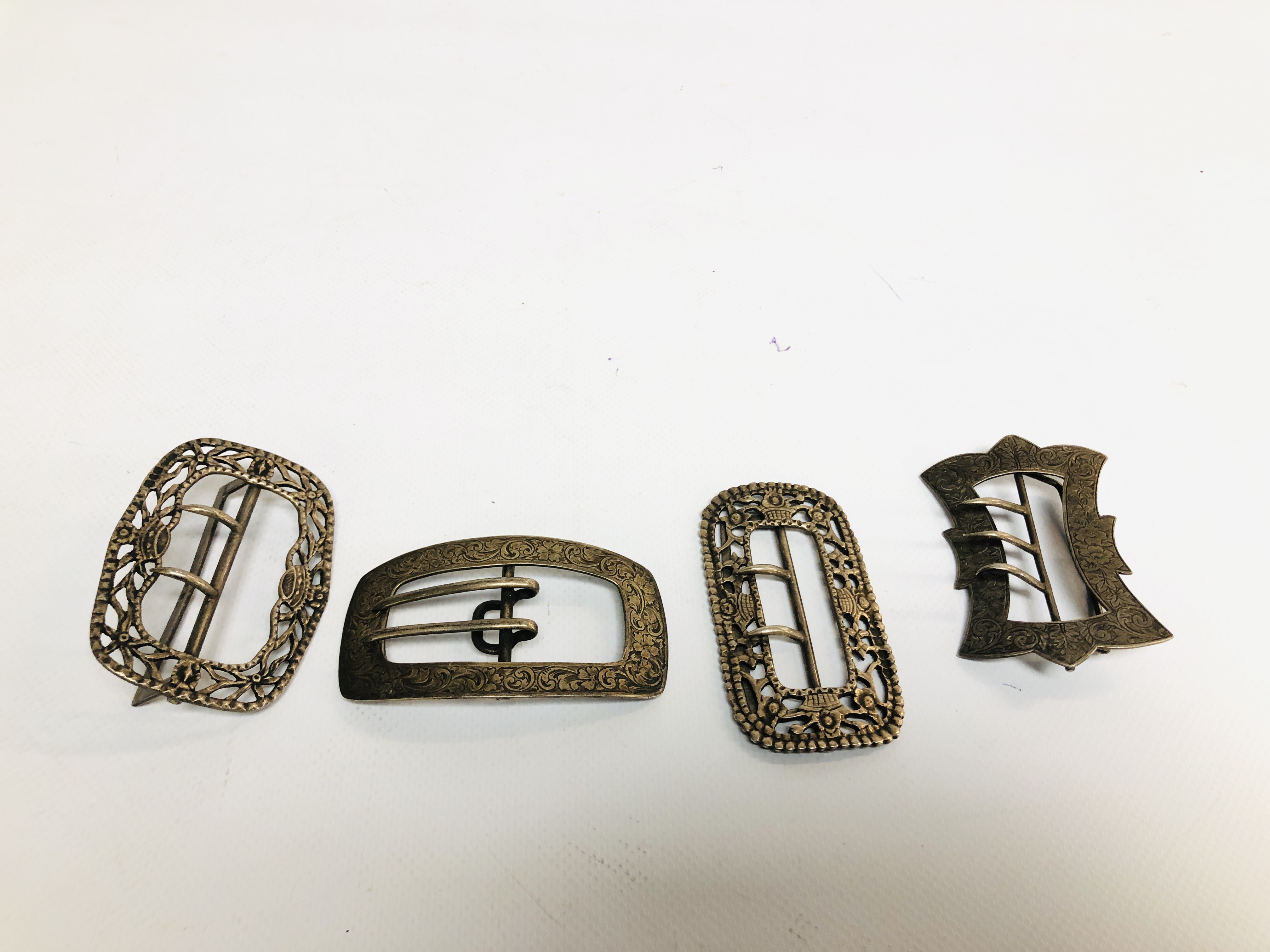 A GROUP OF FOUR VARIOUS SILVER BUCKLES VARIOUS DATES AND MAKERS.