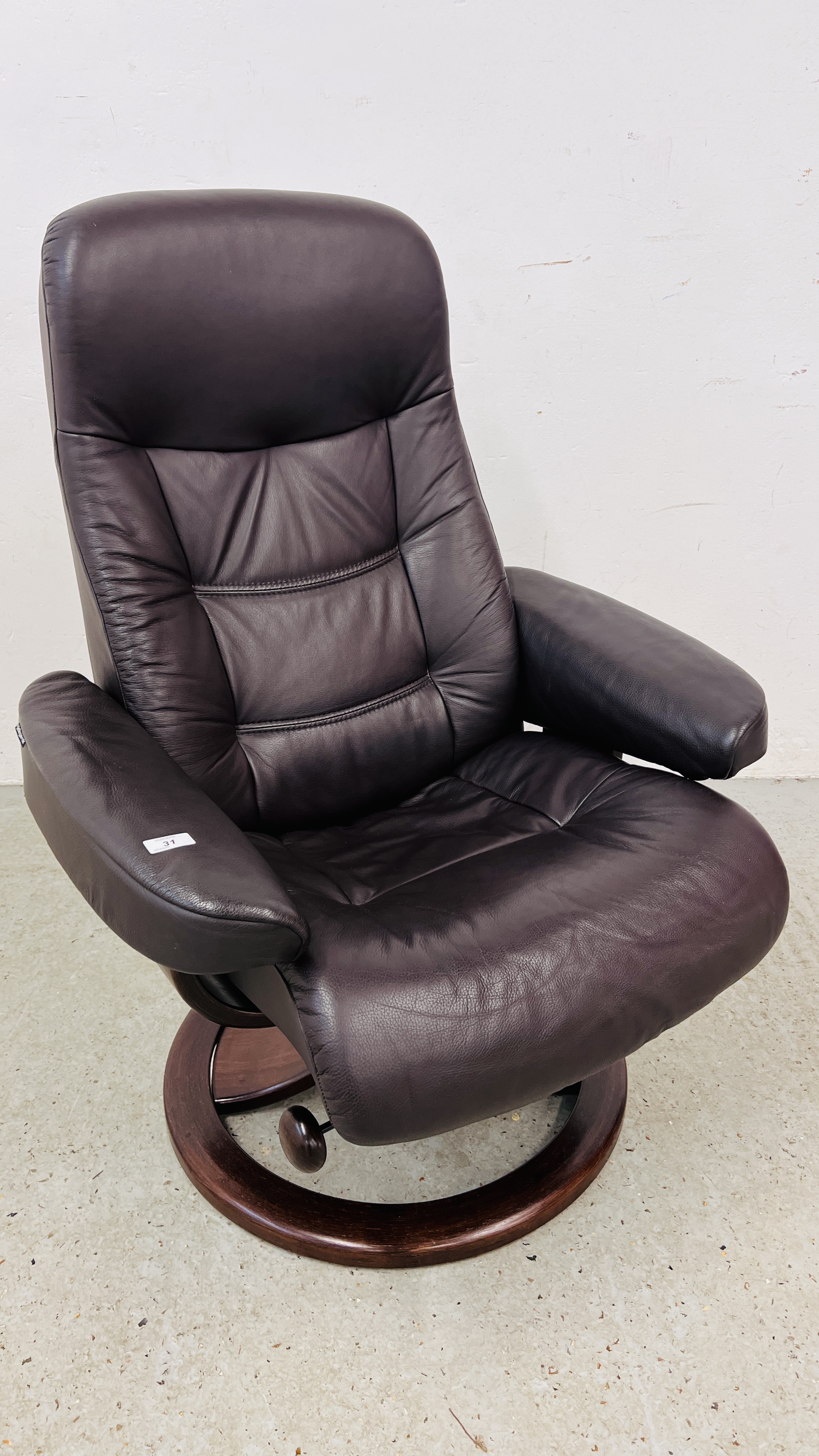 A BROWN LEATHER RELAXER CHAIR