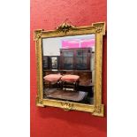A GILT MIRROR IN MID C18TH STYLE WITH OUTSET CORNERS (LATER PLATE) HEIGHT 101CM.