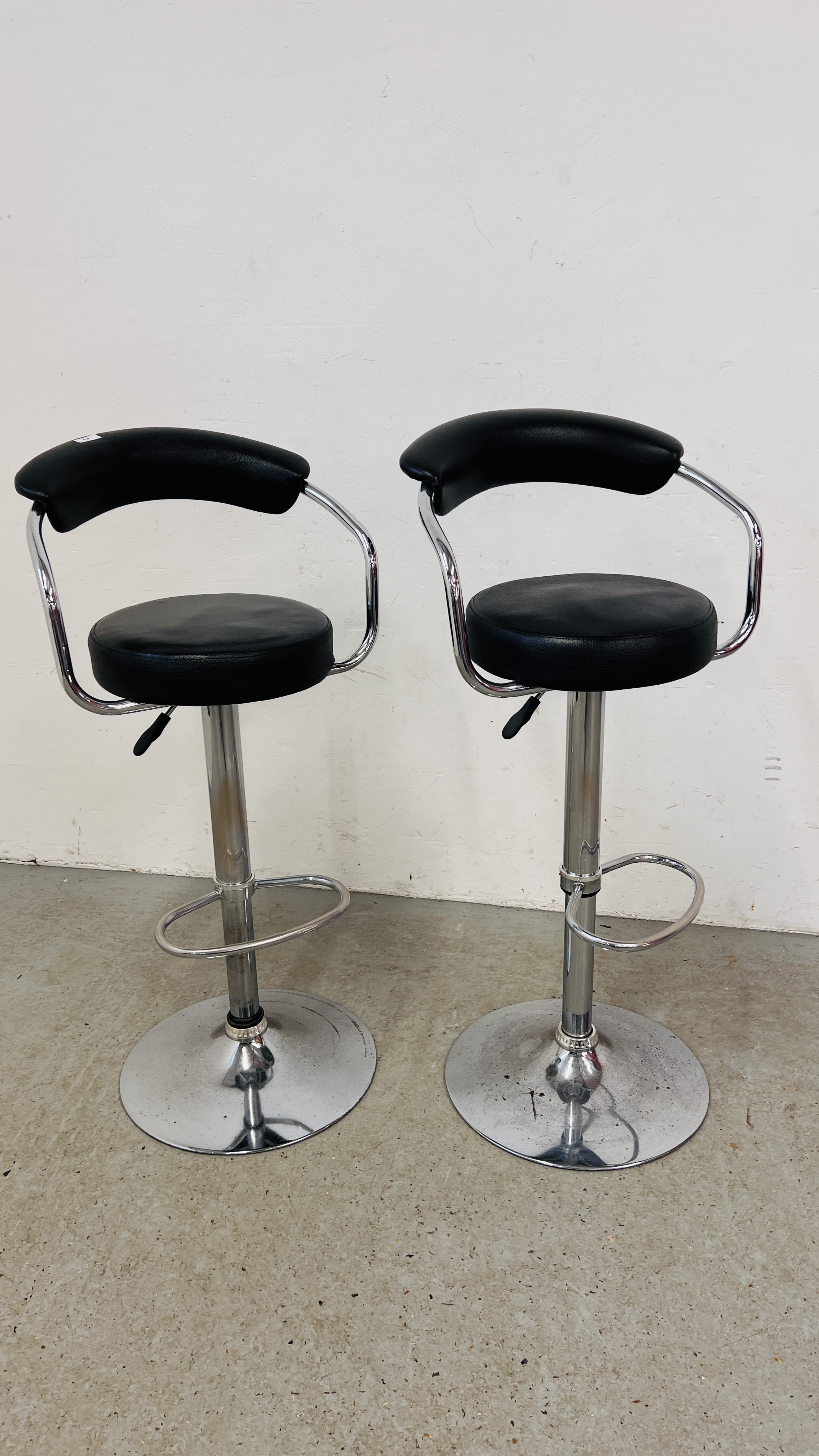 A PAIR OF CHROME FINISH RISE AND FALL BAR STOOLS
