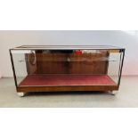 A VINTAGE GLASS DISPLAY CABINET BEARING MAKERS LABEL SAGE & CO LTD.