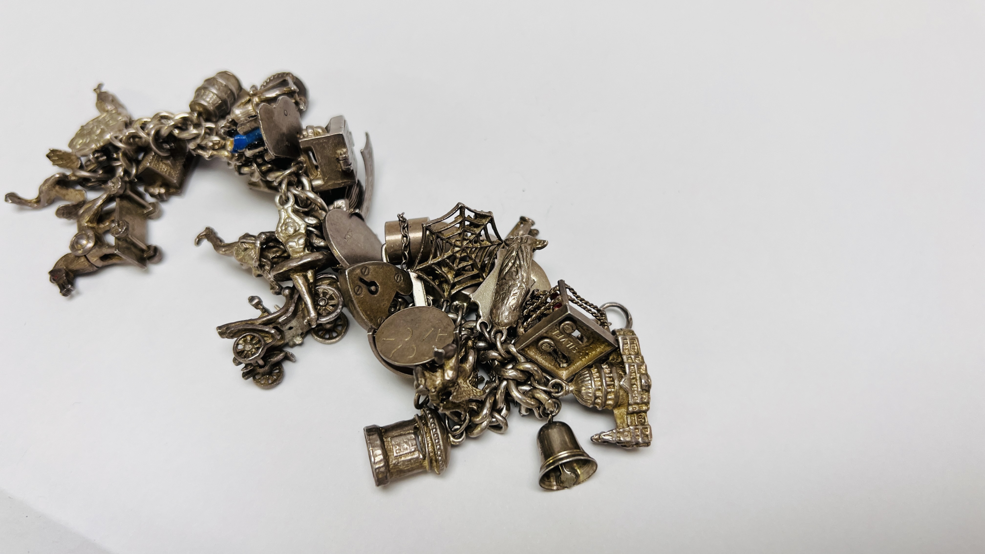 VINTAGE SILVER CHARM BRACELET PADLOCK CLASP WITH APPROX 35 SILVER AND WHITE METAL CHARMS - Image 7 of 8