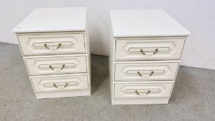 A PAIR OF CREAM FINISH THREE DRAWER BEDSIDE CHESTS