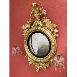 A REGENCY GILT CONVEX MIRROR WITH CANDLE ARMS, HEIGHT OVERALL 101CM.