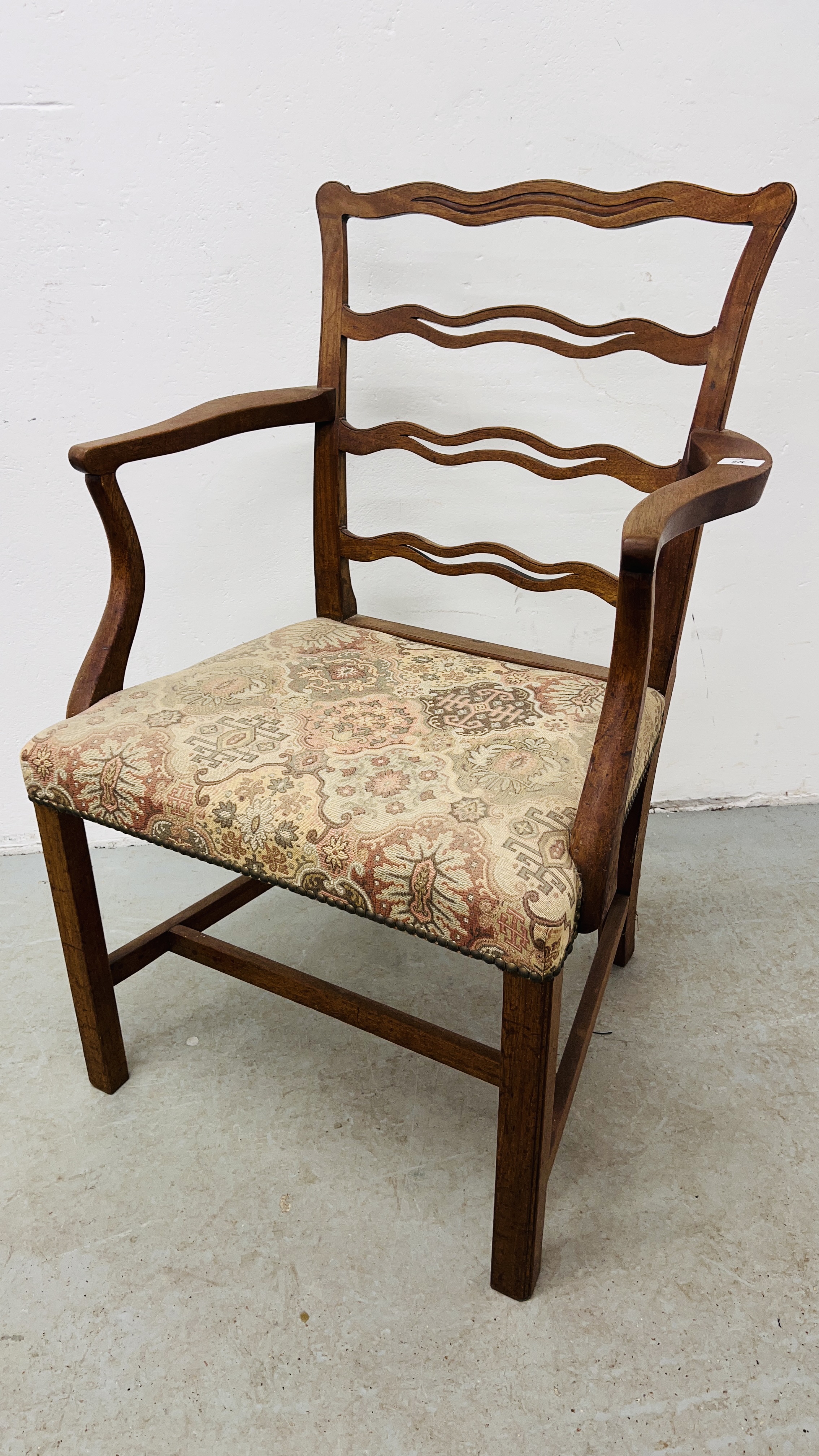 A GEORGE III LADDER BACK OPEN ARM CHAIR