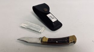 A BUCK KNIFE IN LEATHER POUCH - NO POSTAGE, COLLECTION IN PERSON ONLY.