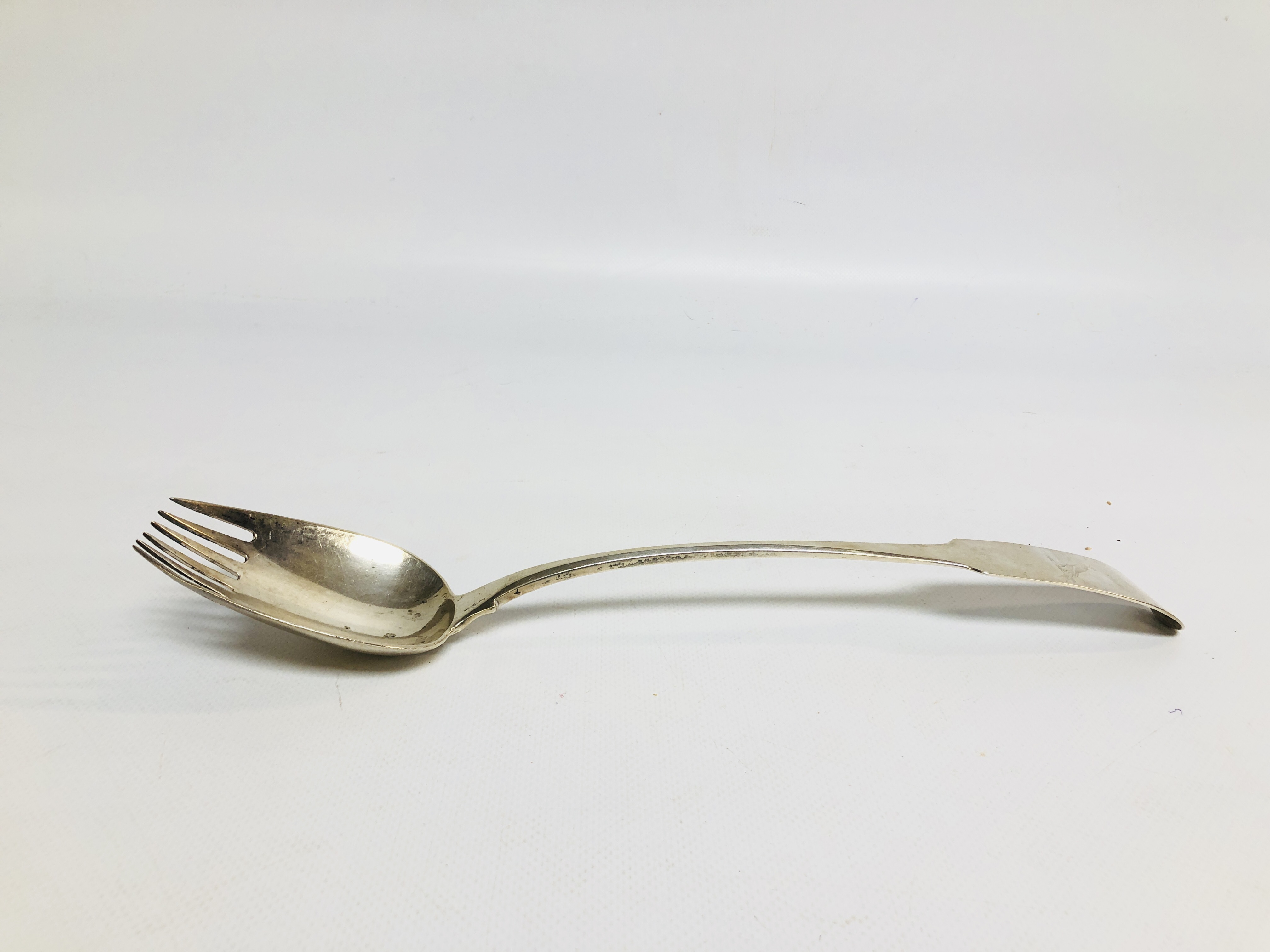 A GEORGE III SILVER FIDDLE PATTERN TINED SERVING SPOON, DUBLIN 1807 BY S.