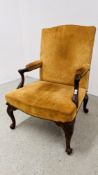 A GEORGE III GAINSBOROUGH CHAIR NOW COVERED IN LEATHER ON CABRIOLE LEGS TERMINATING IN SCROLL FEET.
