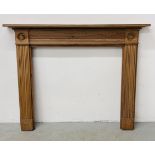 A PINE ANTIQUE FIRE SURROUND WITH BULLSEYE CORNERS (OPENING WIDTH 109CM X 106CM).