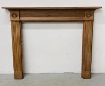 A PINE ANTIQUE FIRE SURROUND WITH BULLSEYE CORNERS (OPENING WIDTH 109CM X 106CM).