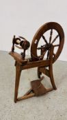 A REPRODUCTION SPINNING WHEEL.