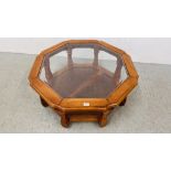 A GLASS TOP OCTAGONAL COFFEE TABLE WITH LOWER BERGERE WORK SHELF