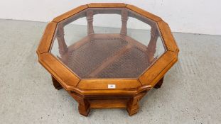 A GLASS TOP OCTAGONAL COFFEE TABLE WITH LOWER BERGERE WORK SHELF