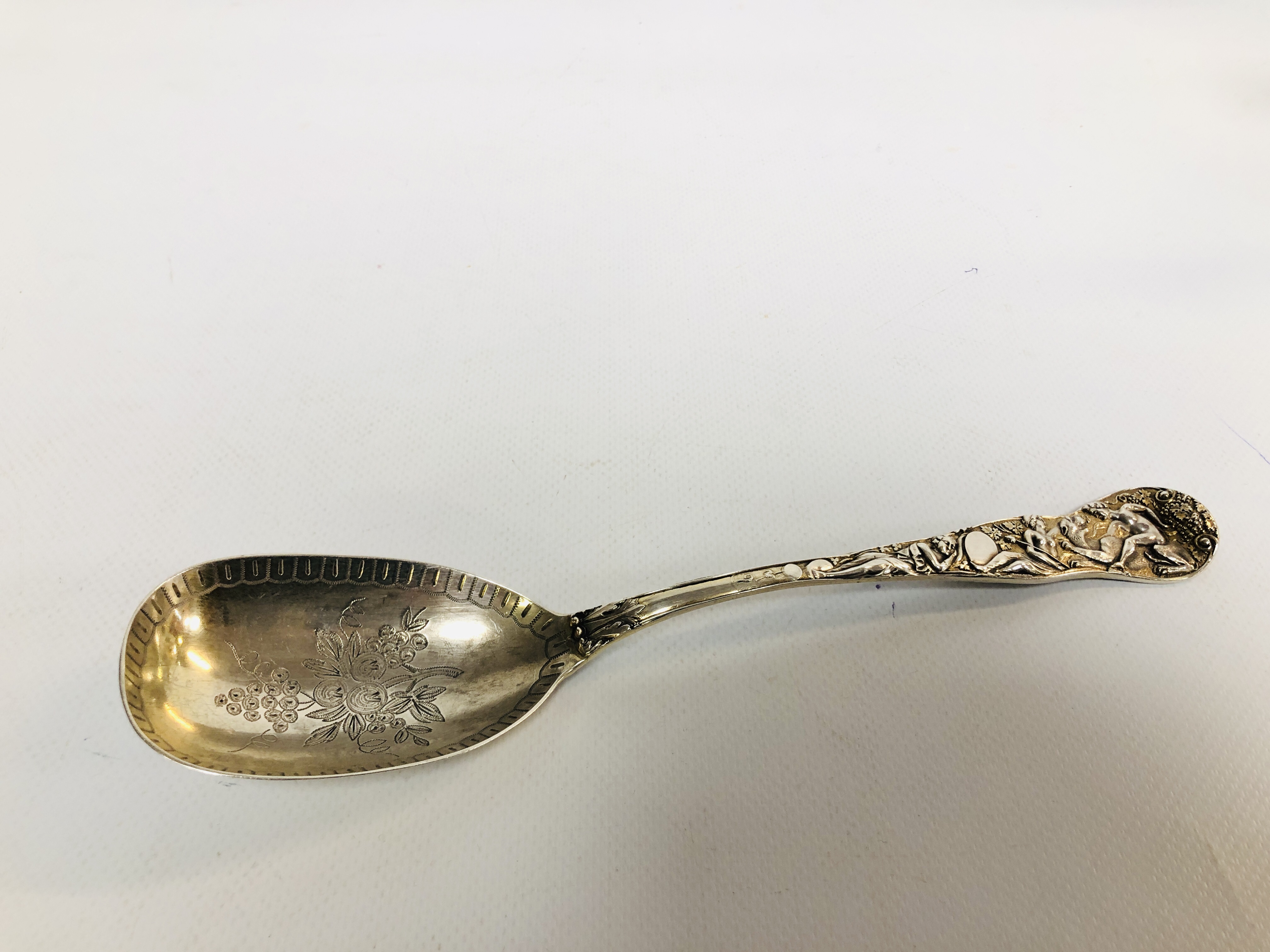 A VICTORIAN SILVER SERVING SPOON DECORATED WITH CLASSICAL FIGURES AND MYTHICAL CREATURES,