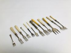 A GROUP OF 12 SILVER PICKLE FORKS, 7 HAVING MOTHER OF PEARL HANDLES, 2 WITH CARVED BONE HANDLES,