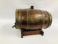 A VINTAGE OAK BRASS BOUND BARREL ON STAND WITH TAP.