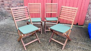 SET OF FOUR TEAK FOLDING GARDEN CHAIRS WITH GREEN CUSHIONED SEATS